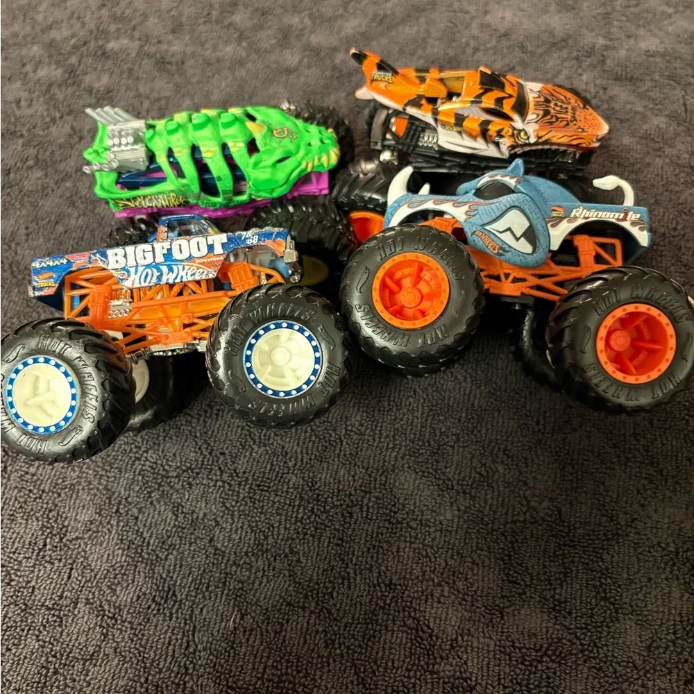 Hot Wheels 4 lot of Monster Truck Toys. Assorted Colors (Green, Orange, Blue)